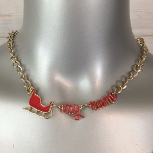 Holiday Arcade Sleigh My Name gold tone necklace